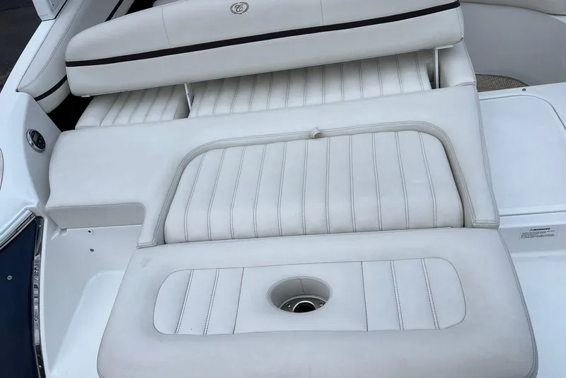 Slide: The Image of 2015 Cobalt R5 boat interior with white cushioned seating and sleek design. - 17