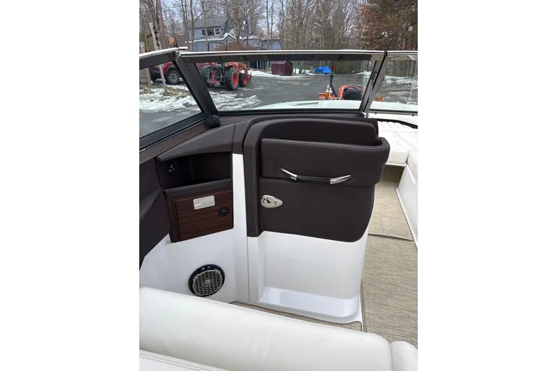 Slide: The Image of 2015 Cobalt R5 boat interior with brown and white seating, outdoor background. - 19