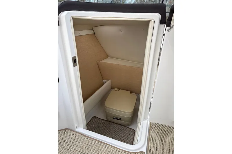 Slide: The Image of Compact bathroom inside 2015 Cobalt R5 boat, featuring a portable toilet. - 20