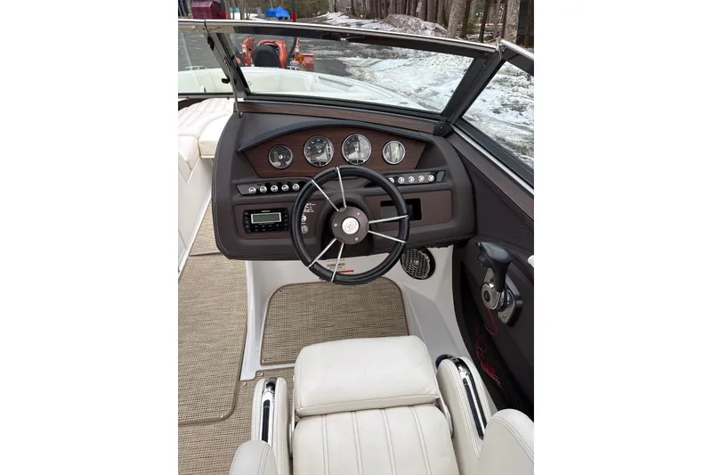 Slide: The Image of Interior view of a 2015 Cobalt R5 boat dashboard with steering wheel and gauges. - 22