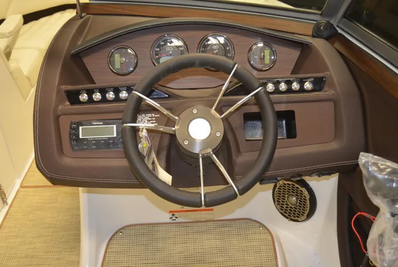 Slide: The Image of Dashboard of a 2015 Cobalt R5 boat with steering wheel and gauges. - 24