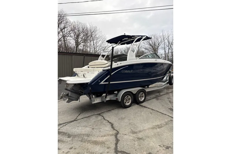 Slide: The Image of 2015 Cobalt R5 boat on trailer, parked outdoors, overcast sky. - 3