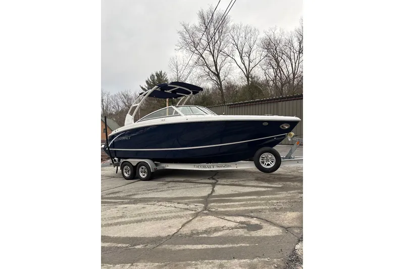 Slide: The Image of 2015 Cobalt R5 boat on trailer, parked outdoors, with overcast sky. - 5