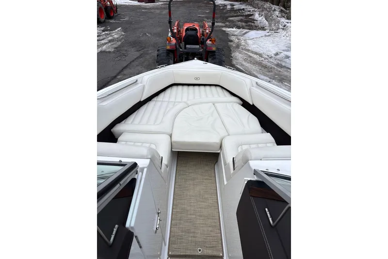 Slide: The Image of 2015 Cobalt R5 boat interior with white seating and a tractor in the background. - 9