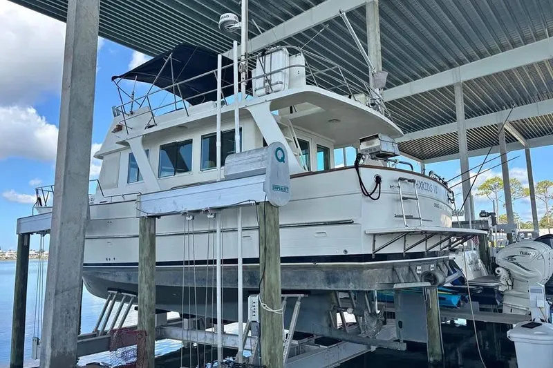 Slide: The Image of 2006 Mariner Orient boat docked under a covered marina, side view. - 11