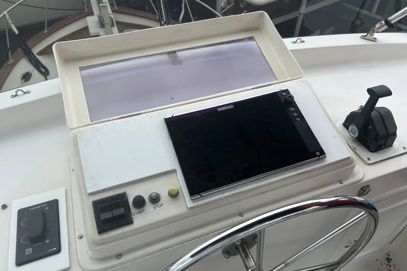 Slide: The Image of 2006 Mariner Orient boat dashboard with navigation controls and steering wheel. - 15