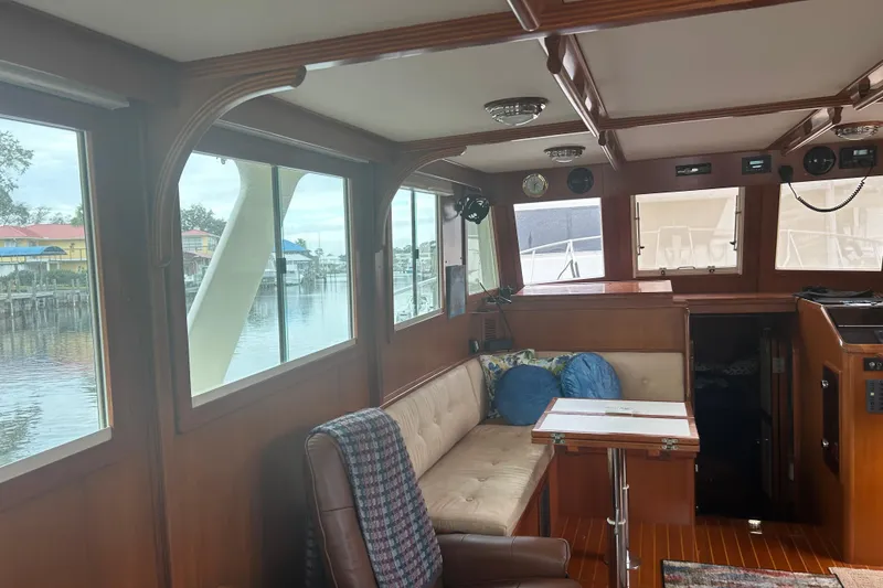 Slide: The Image of Interior of 2006 Mariner Orient boat with wood paneling and seating area. - 18