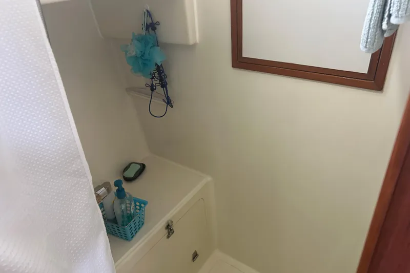 Slide: The Image of Compact bathroom in 2006 Mariner Orient boat with toiletries and shower essentials. - 19