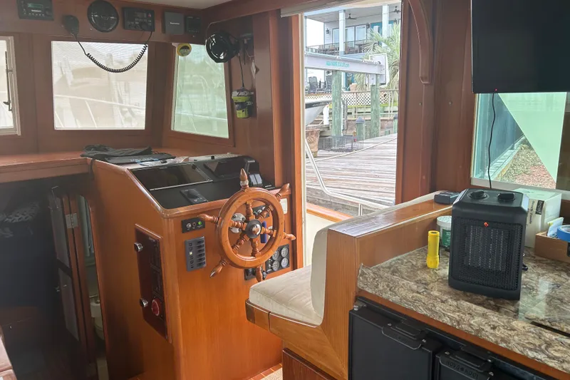 Slide: The Image of Interior of 2006 Mariner Orient boat with wooden helm and modern controls. - 20