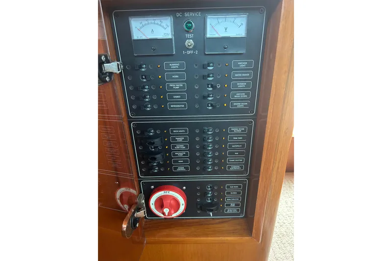 Slide: The Image of Electrical control panel on a 2006 Mariner Orient boat, featuring switches and gauges. - 22