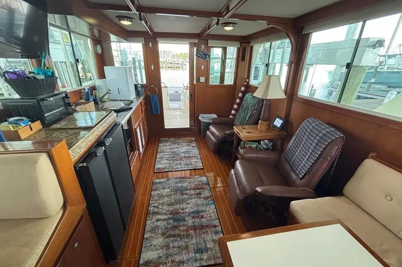 Slide: The Image of Interior of 2006 Mariner Orient boat with cozy seating and wooden flooring. - 4