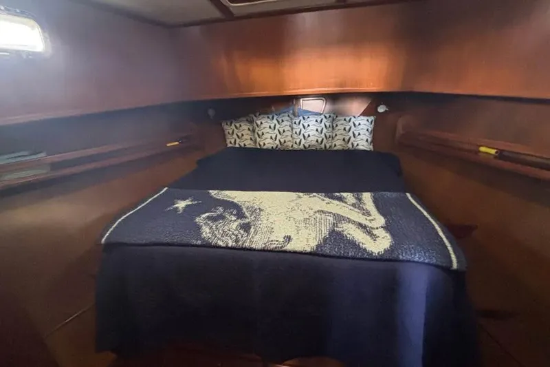 Slide: The Image of Cozy cabin interior of 2006 Mariner Orient with nautical-themed bedding. - 8