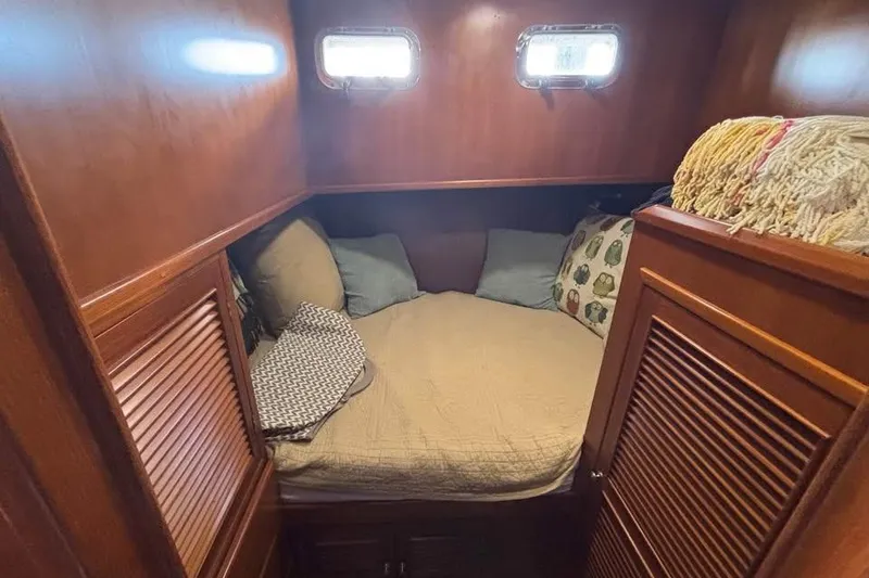 Slide: The Image of Cozy cabin interior of 2006 Mariner Orient boat with wooden finish and bedding. - 9