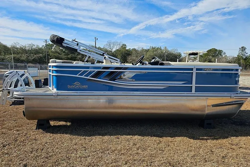The Image of 2026 SunCatcher Select 20C pontoon boat, blue and silver, parked on grass under a clear sky. - 1