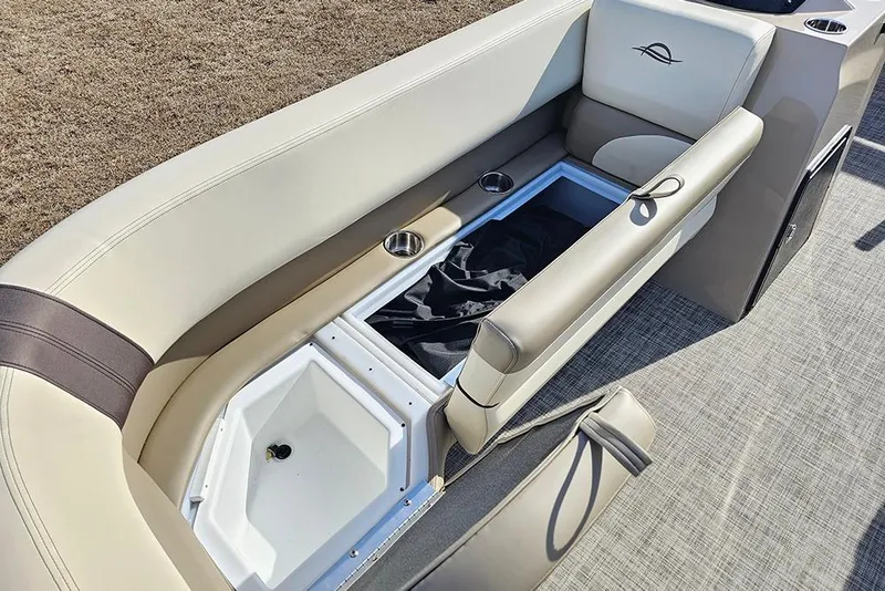 Slide: The Image of 2026 SunCatcher Select 20C boat interior with storage compartment and cup holders. - 21