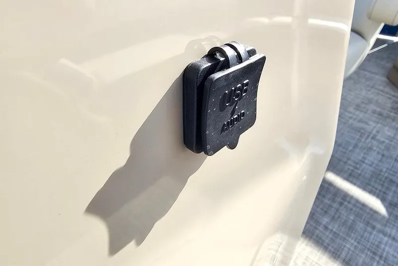 Slide: The Image of USB audio port on 2026 SunCatcher Select 20C boat, beige surface background. - 24