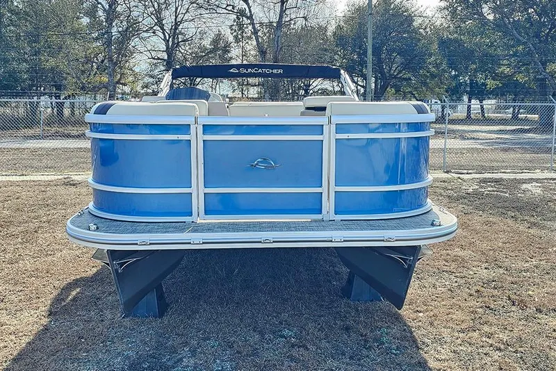 Slide: The Image of 2026 SunCatcher Select 20C pontoon boat, blue exterior, parked on grass. - 4