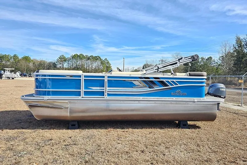 Slide: The Image of 2026 SunCatcher Select 20C pontoon boat with Yamaha motor, parked on grass. - 6