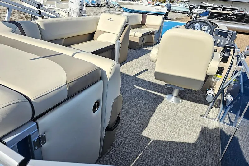 Slide: The Image of Interior of 2026 SunCatcher Select 20C boat with beige seating and modern controls. - 9