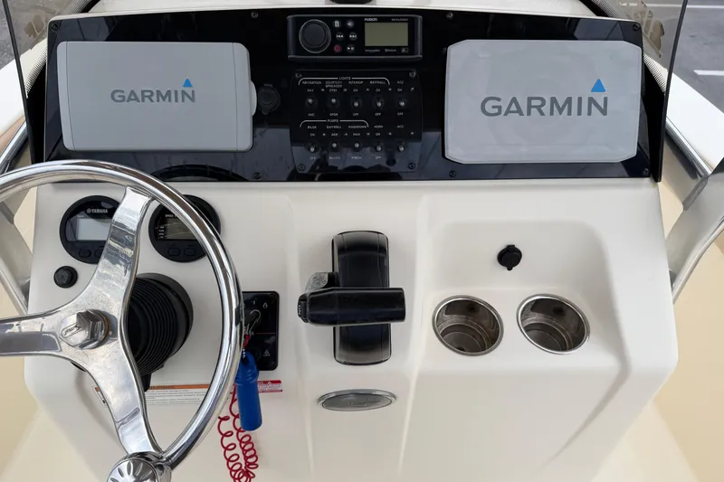 Slide: The Image of 2020 Scout 215 XSF boat dashboard with Garmin displays and steering wheel. - 10