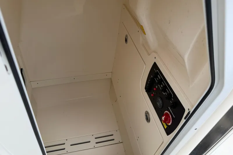 Slide: The Image of 2020 Scout 215 XSF boat interior compartment with control panel. - 11