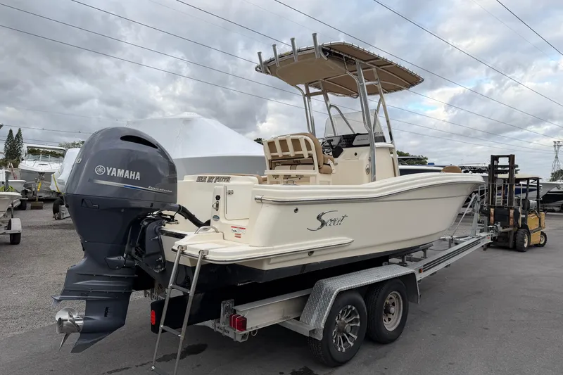 Slide: The Image of 2020 Scout 215 XSF boat on trailer with Yamaha engine, parked outdoors. - 2