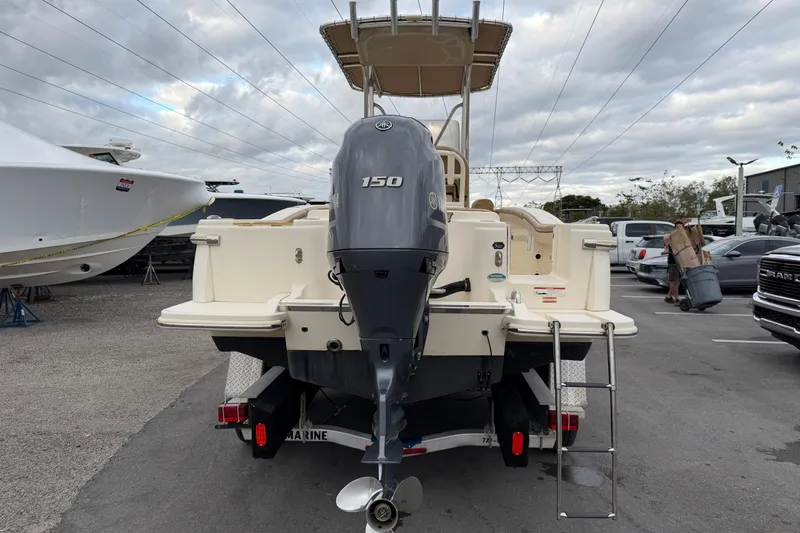 Slide: The Image of 2020 Scout 215 XSF boat with Yamaha 150 engine, parked outdoors. - 3