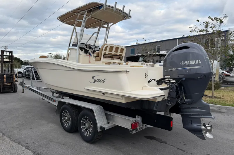 Slide: The Image of 2020 Scout 215 XSF boat on trailer with Yamaha outboard motor, parked outdoors. - 4