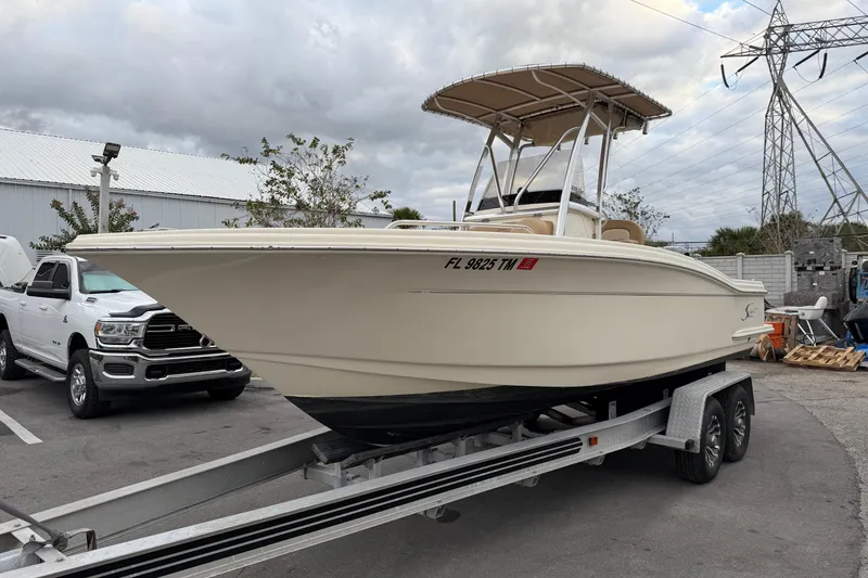 Slide: The Image of 2020 Scout 215 XSF boat on trailer, parked beside a white truck. - 5