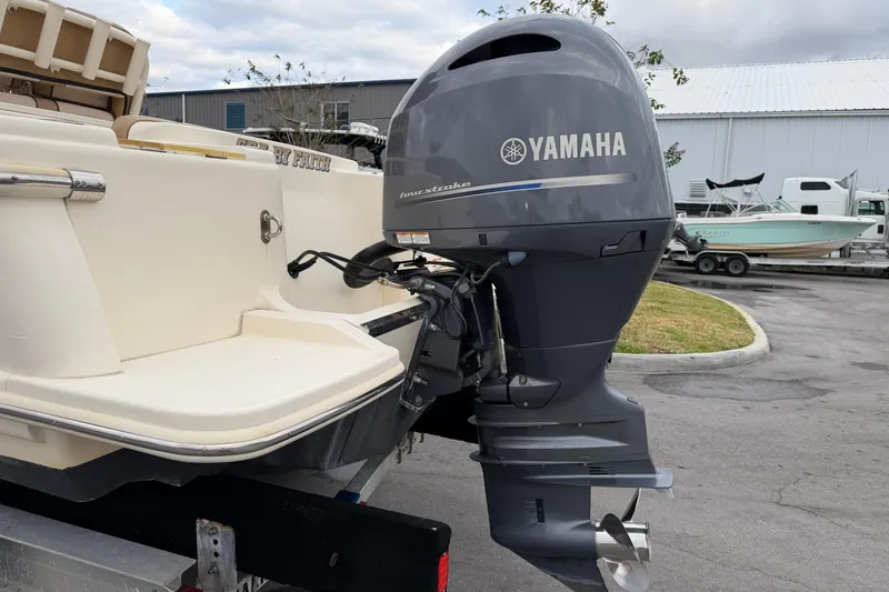 Slide: The Image of 2020 Scout 215 XSF boat with Yamaha outboard motor in a parking area. - 6