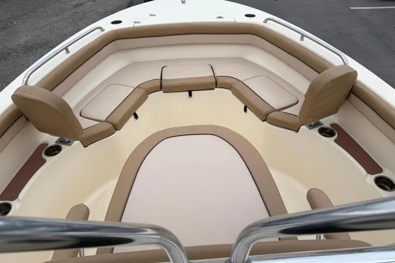 Slide: The Image of 2020 Scout 215 XSF boat interior with tan cushioned seating and cup holders. - 9