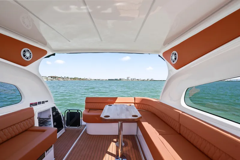 Slide: The Image of Luxurious interior of 2026 Hanover 355 boat with brown seating and scenic water view. - 14