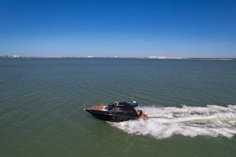 Slide: The Image of 2026 Hanover 355 boat cruising on open water under clear blue sky. - 3