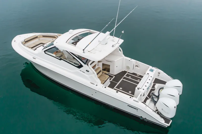 Slide: The Image of 2018 Pursuit boat with triple outboard engines on calm water. - 7