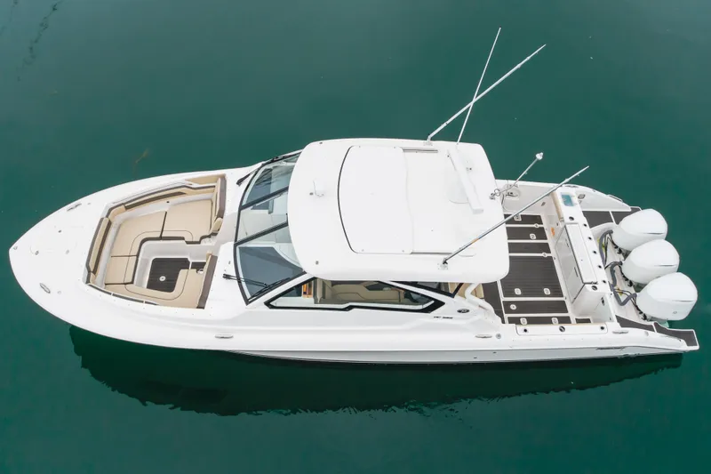 Slide: The Image of Aerial view of 2018 Pursuit boat with triple engines on calm water. - 9