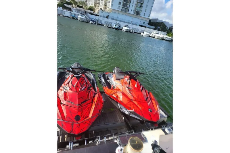Slide: The Image of Two red jet skis docked on a 1999 Sea Ray 630 Sundancer yacht. - 3