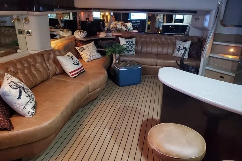 Slide: The Image of Luxurious interior of 1999 Sea Ray 630 Sundancer yacht with leather seating and nautical decor. - 8