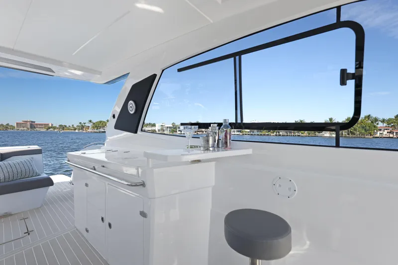Slide: The Image of Interior of 2025 Valiatt 380 Bowrider yacht with bar and seating, overlooking water. - 10