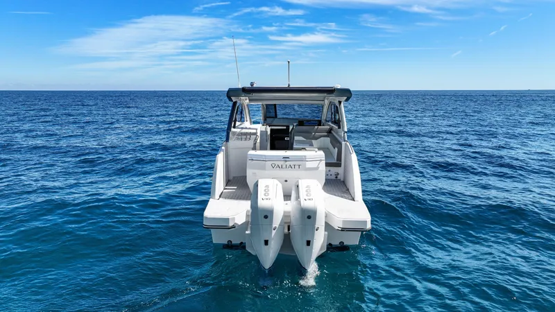 Slide: The Image of 2025 Valiatt 380 Bowrider boat on open sea, rear view, clear blue sky. - 2