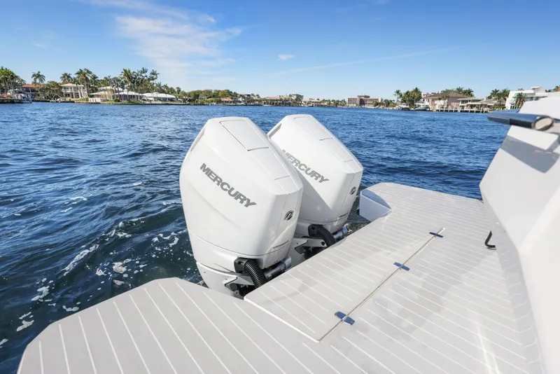 Slide: The Image of 2025 Valiatt 380 Bowrider with dual Mercury outboard engines on a sunny waterfront. - 4