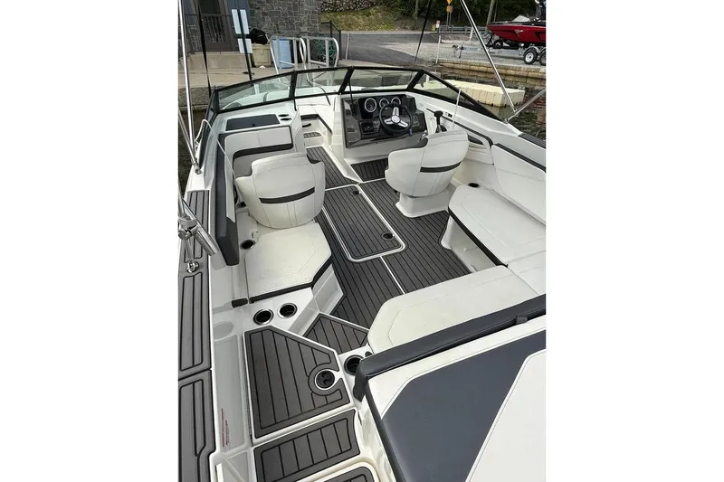 Slide: The Image of 2018 Sea Ray SPX 210 boat interior with sleek seating and modern dashboard design. - 2