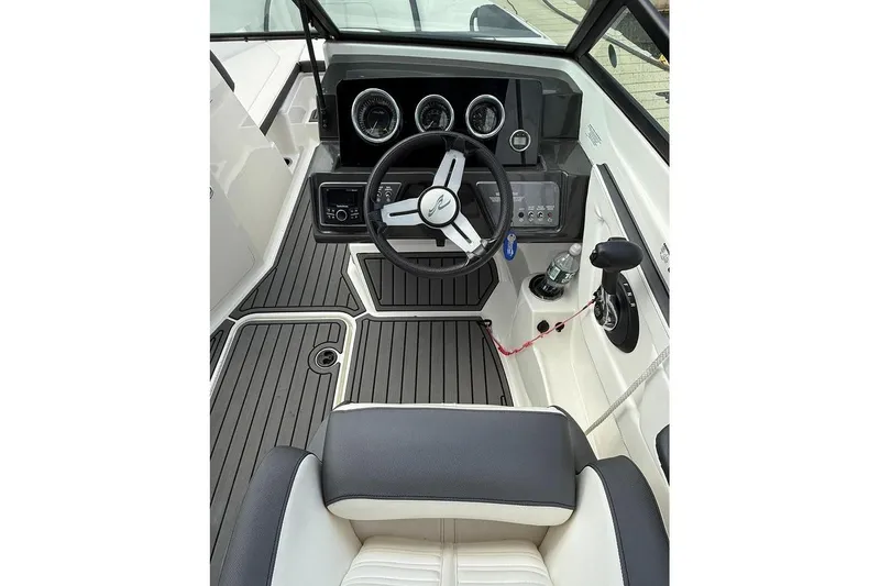 Slide: The Image of 2018 Sea Ray SPX 210 boat cockpit with steering wheel and dashboard controls. - 4