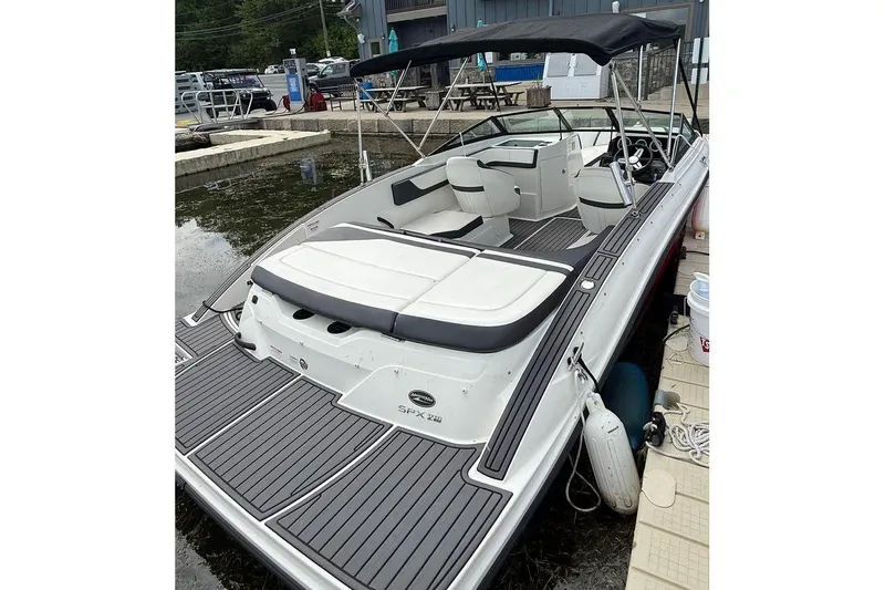 Slide: The Image of 2018 Sea Ray SPX 210 boat docked, featuring sleek design and comfortable seating. - 9