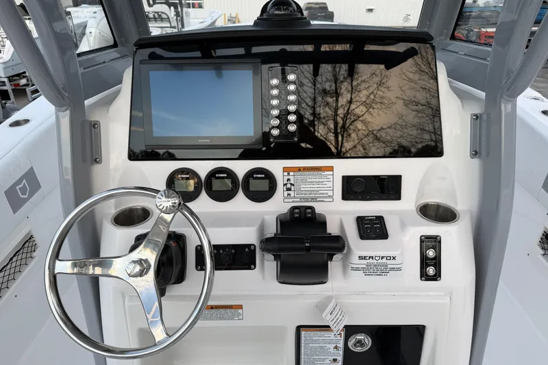 Slide: The Image of 2026 Sea Fox 268 Commander dashboard with steering wheel and navigation controls. - 10