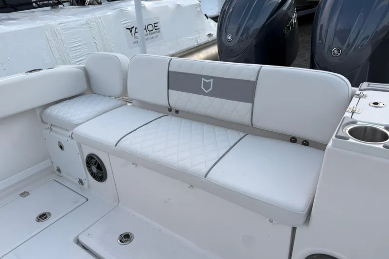 Slide: The Image of 2026 Sea Fox 268 Commander boat seating area with white cushioned seats and cup holders. - 13