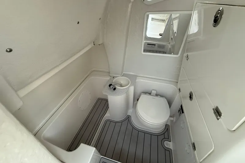 Slide: The Image of 2026 Sea Fox 268 Commander boat bathroom with toilet, sink, and mirror. - 4