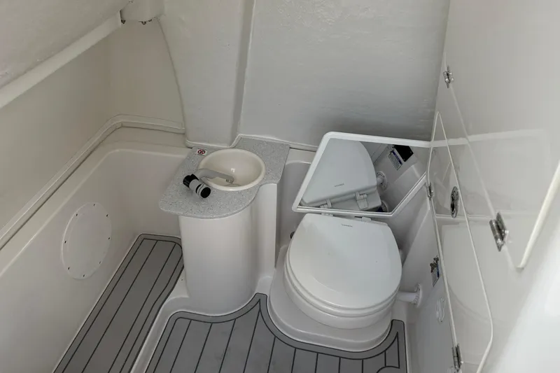 Slide: The Image of 2026 Sea Fox 268 Commander boat bathroom with toilet, sink, and mirror. - 5