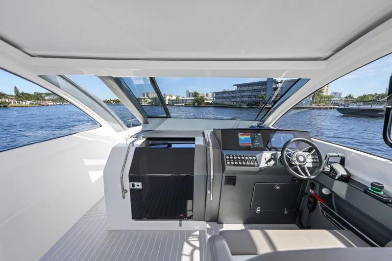 Slide: The Image of Interior view of 2025 VALIATT YACHTS 380 Bowrider, featuring modern helm and waterfront backdrop. - 2