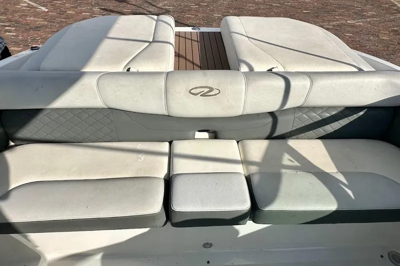 Slide: The Image of 2012 Regal 2100 Bowrider boat interior with cushioned seating and elegant design. - 18