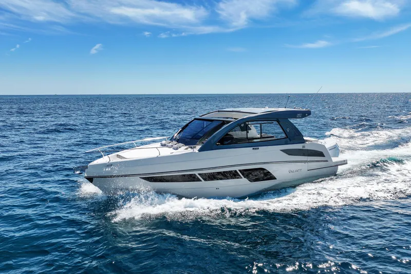 Slide: The Image of 2025 VALIATT YACHTS 380 Bowrider cruising on open sea under clear blue sky. - 13